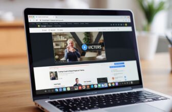 Laptop displaying online lecture video with subtitles