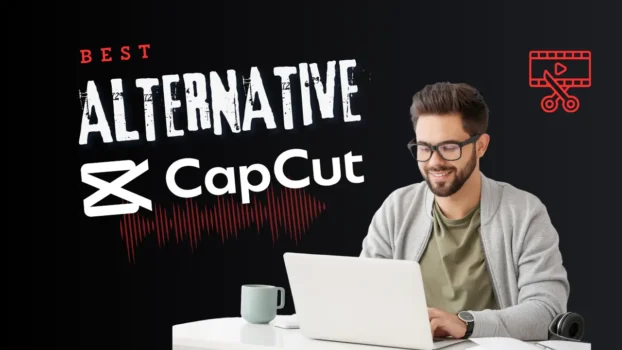 Smiling man using laptop with video editing software