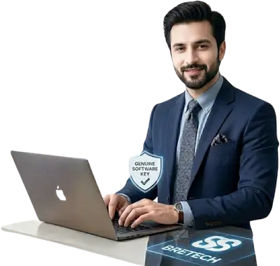 Man in suit using laptop with software key badge